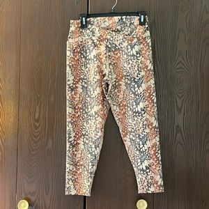 Evolution and Creation orange/cream/black patterned athletic pants. Size Large.